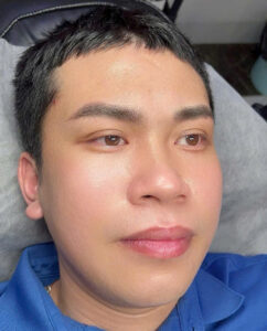 Close-up of a man's defined and well-groomed eyebrows after a microblading procedure.