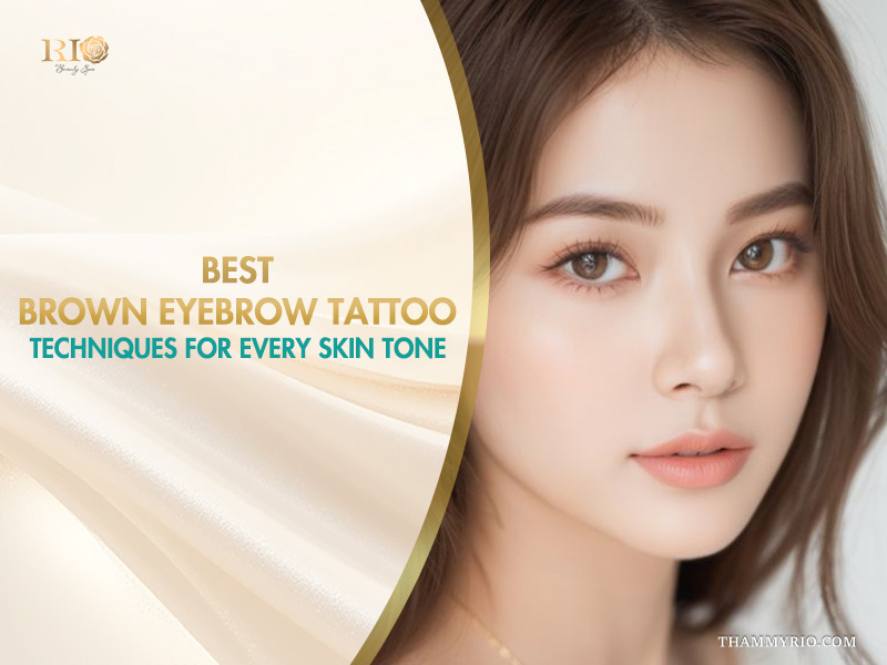 A young woman with a soft brown eyebrow tattoo looking elegantly at the camera.