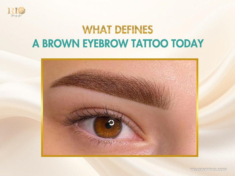 Close-up of a perfectly shaded brown eyebrow tattoo with natural hair strokes.