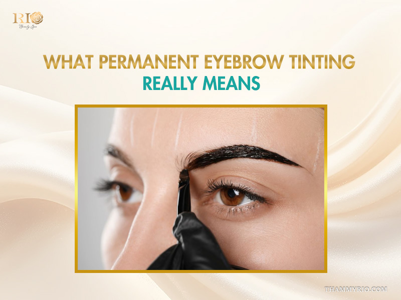 Close-up of a technician applying dye during a permanent eyebrow tinting procedure.