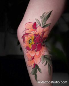A vibrant peony tattoo on the knee excellent for covering nee surgery scar tattoos in Hanoi.