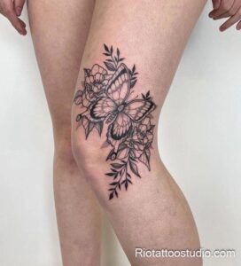 Butterfly and floral knee surgery scar tattoos in Hanoi studio.