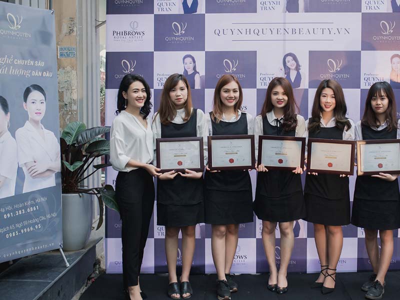professional staff receiving certificate for cosmetic tattoo near me in hanoi