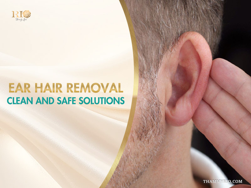 A close-up of a person touching their ear in natural bathroom light, considering ear hair removal methods.