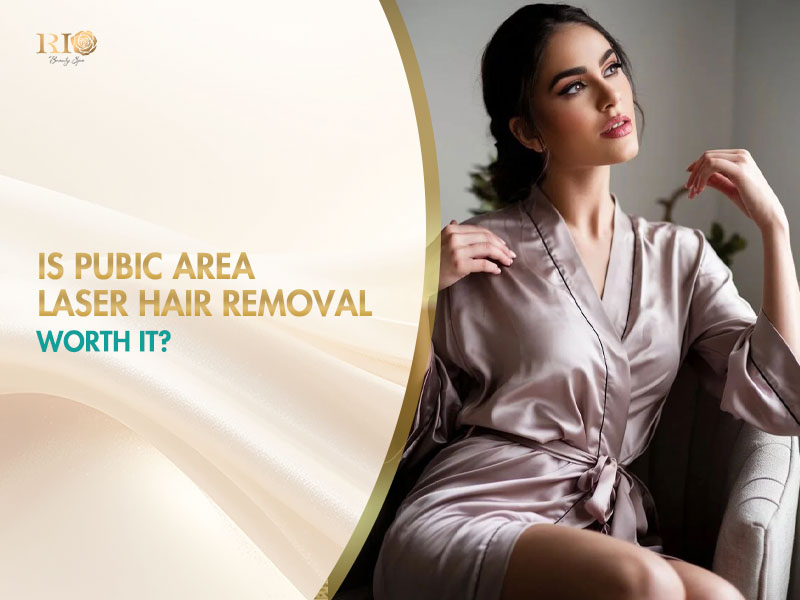 A confident young woman in a silk bathrobe relaxes on a sofa, enjoying comfort after pubic area laser hair removal.