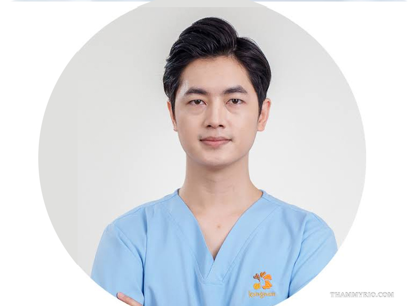 Portrait of a professional laser tattoo removal specialist in a blue uniform.