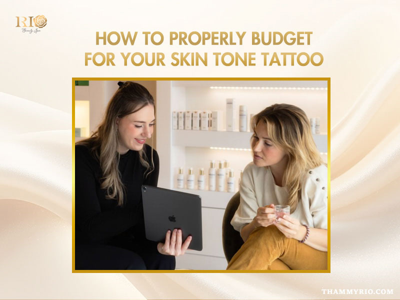 A beauty consultant discussing pricing and budget options for a skin tone tattoo with a client using a tablet.
